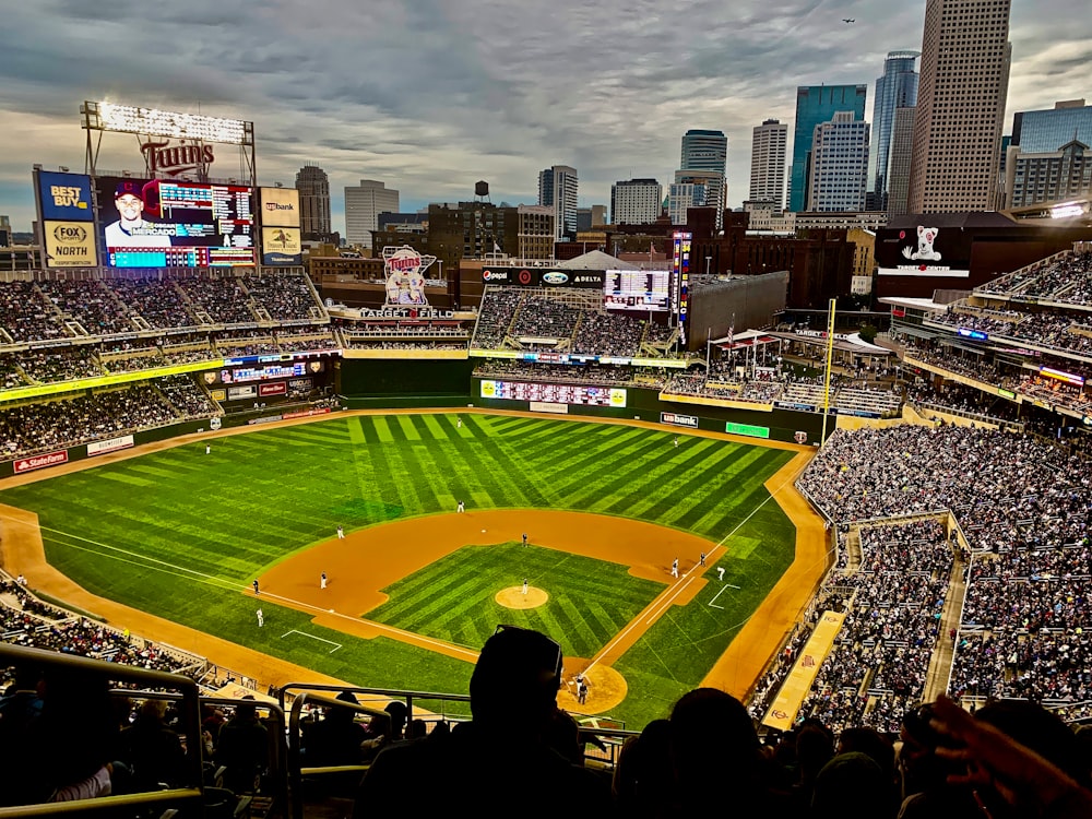 green and brown baseball stadium with people watching during daytime