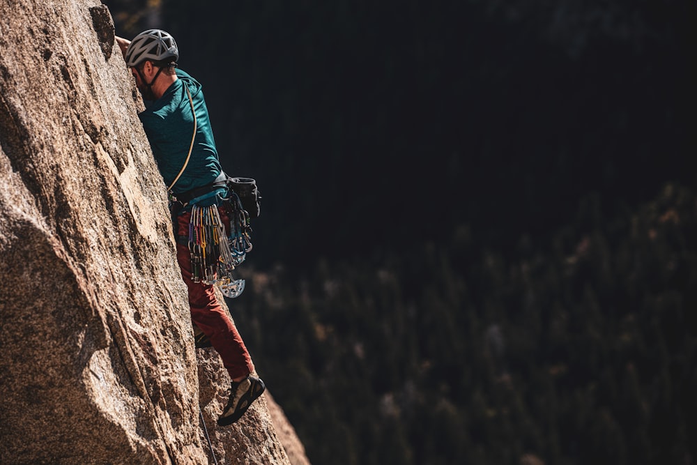 man wearing helmet hiking during daytime