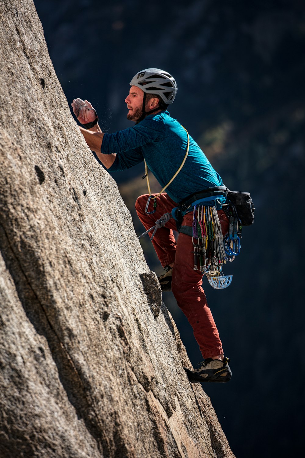 selective focus photography of man climbing on mountain