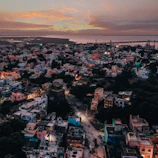 A vibrant aerial view of a bustling residential neighborhood in Tamil Nadu at sunset.