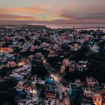 A vibrant aerial view of a bustling residential neighborhood in Tamil Nadu at sunset.