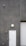 A utilitarian gray building exterior featuring a white door marked with 'TEC 3' and a dome-shaped light fixture above. A surveillance camera is mounted high on the wall, alongside a small, red fire alarm. A corrugated metal roller door is partially visible.