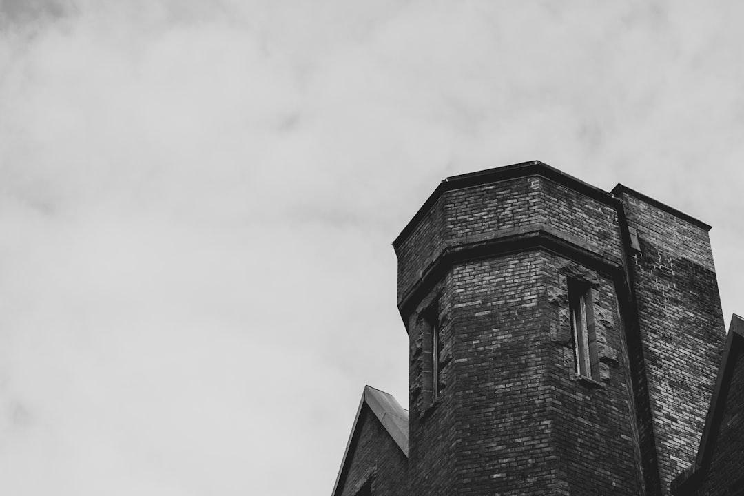 grayscale photo of a brick house