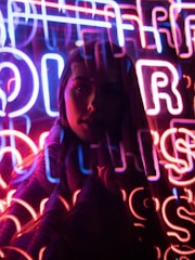 Neon-blue and pink cyberpunk background with an alluring blonde woman in leather, inviting and stylish