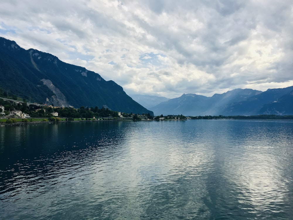 body of water under cloudy sky