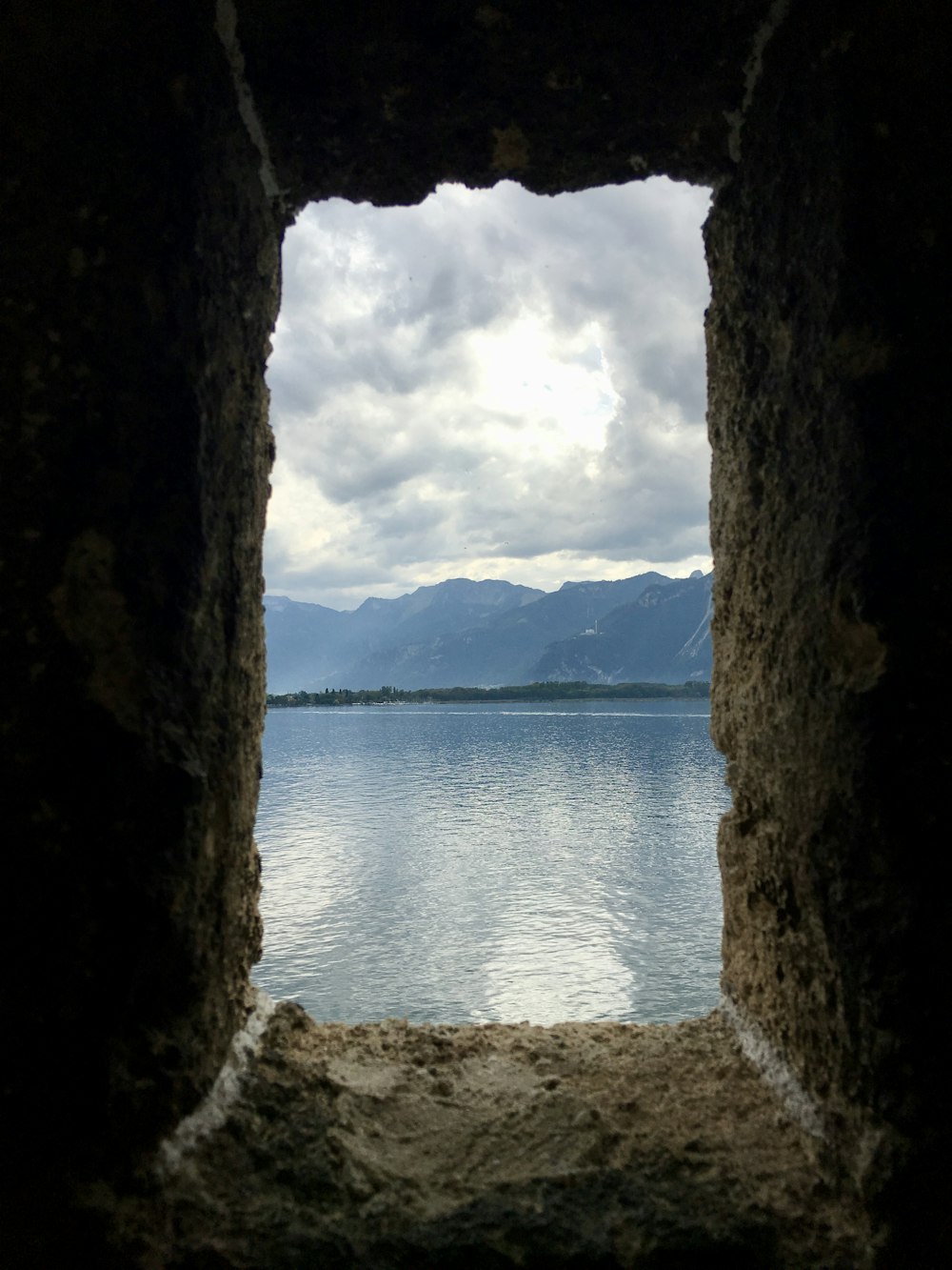 brown cave viewing body of water