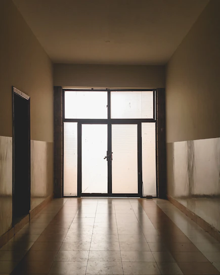 A frosted glass office door etched with the Prayter & Prayter, Ltd. logo, bathed in soft bone-colored light.