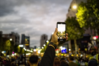 man holding smartphone while rising on air