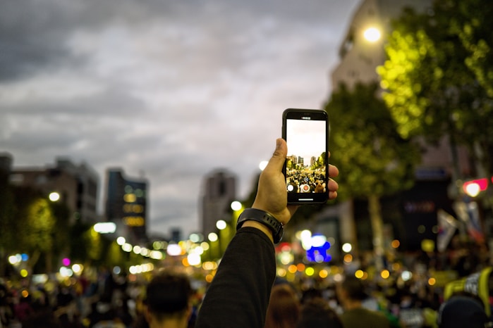 man holding smartphone while rising on air