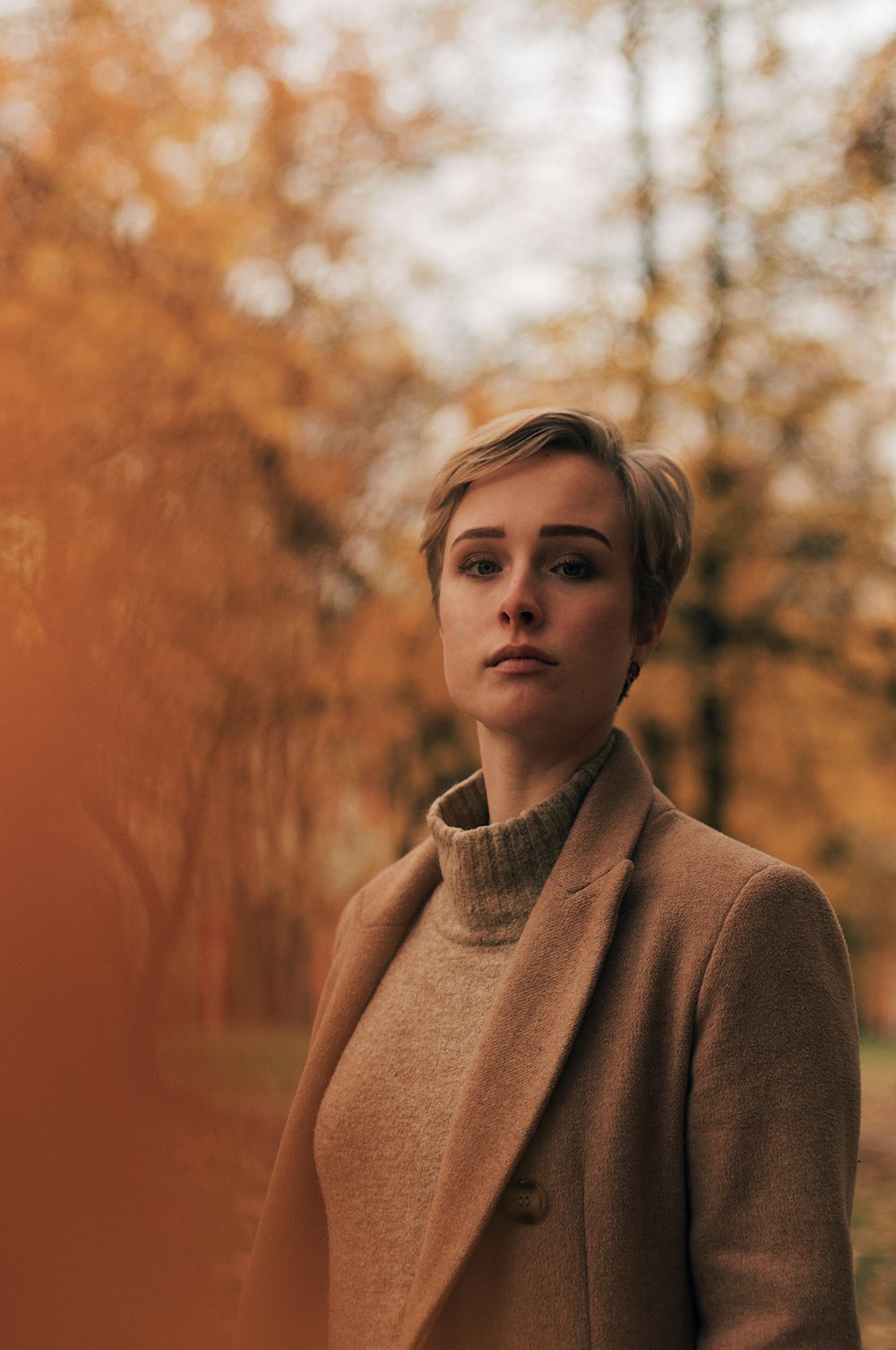 selective focus photography of woman in brown blazer