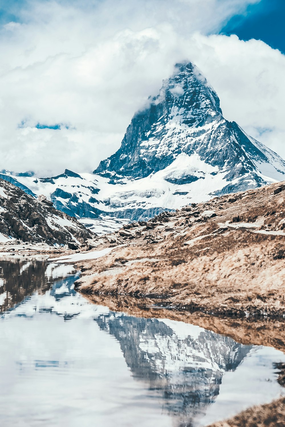 body of water and mountains during day