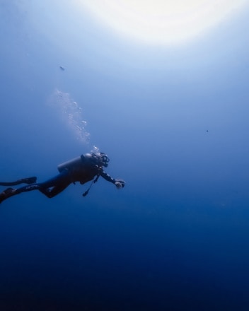 person swimming under water photography