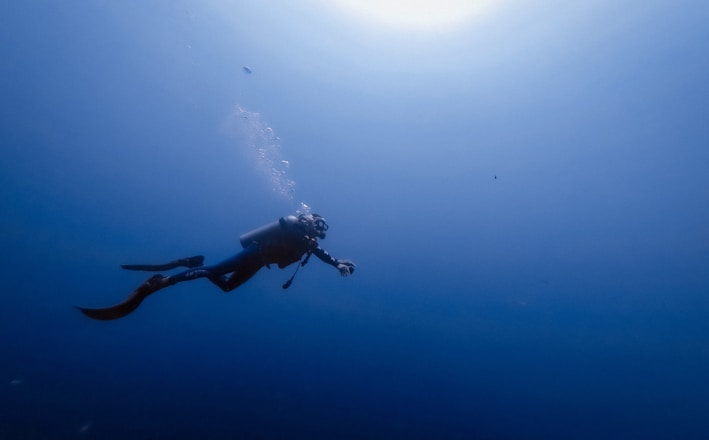 person swimming under water photography