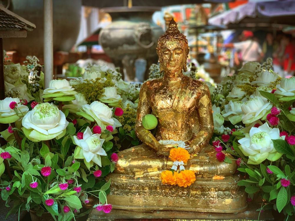 Buddha figure surrounded by white flowers