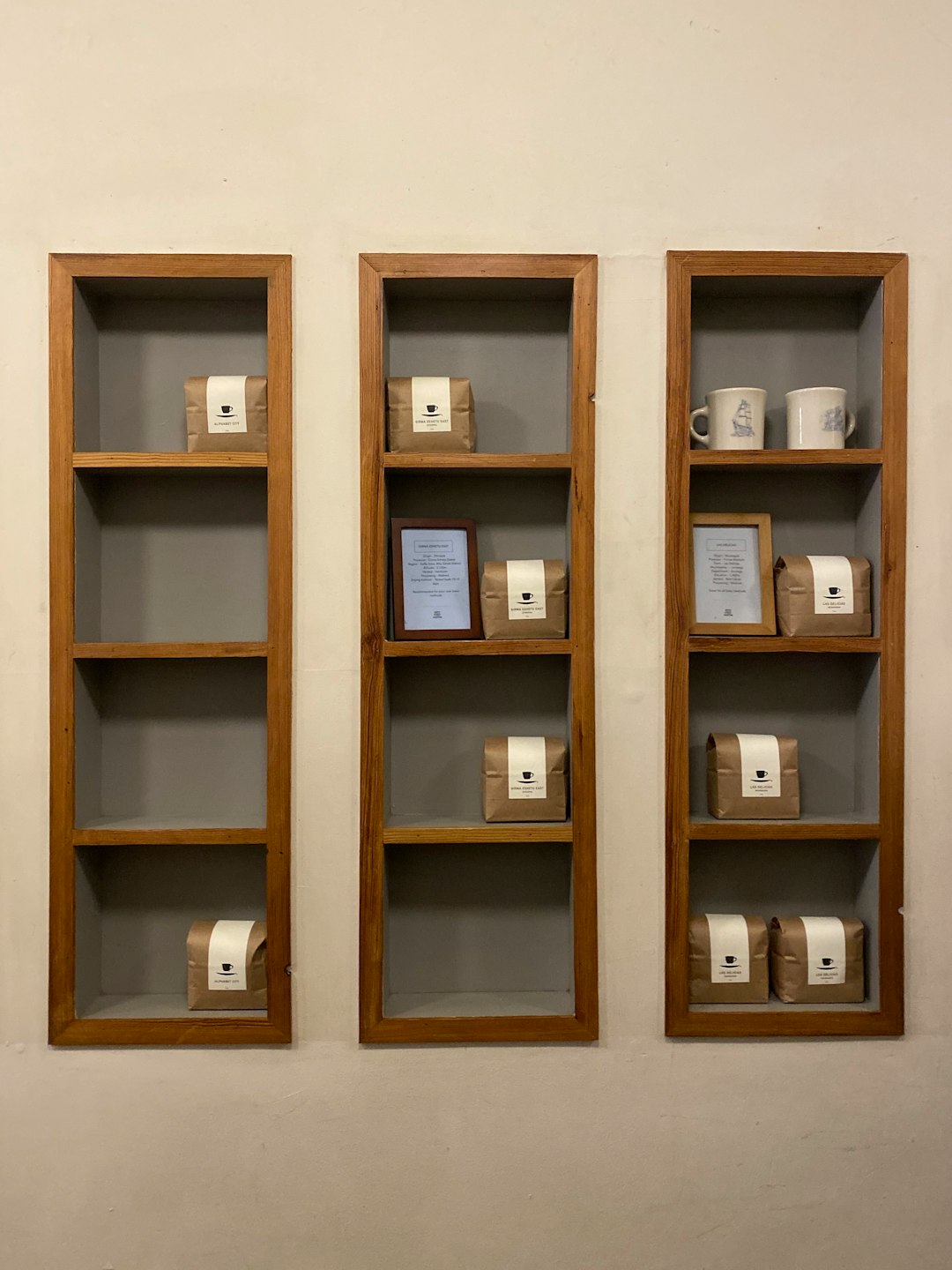 boxes and mugs on brown wooden floating shelves