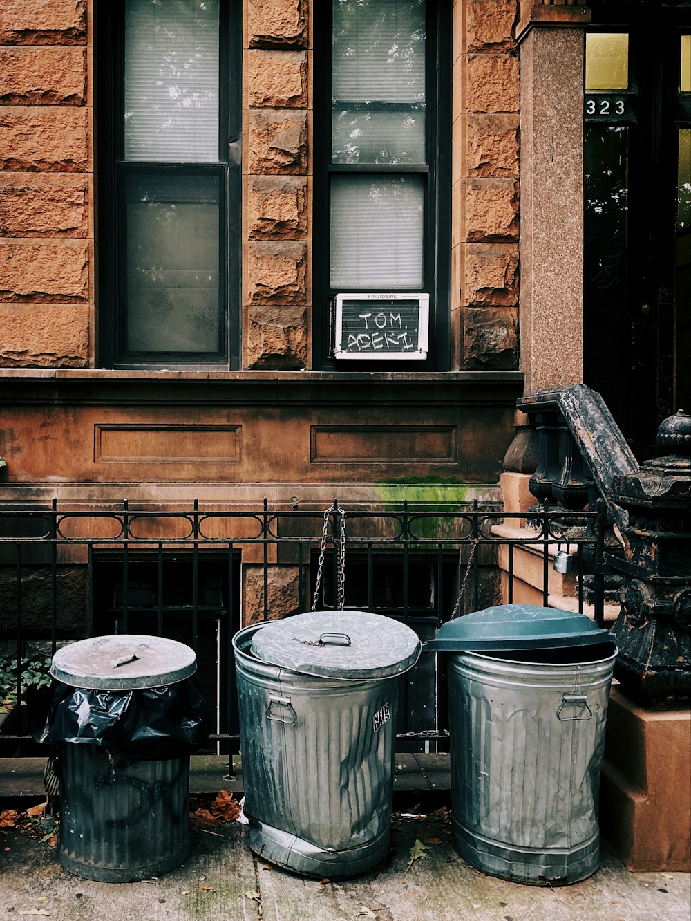 three gray stainless steel trash bins