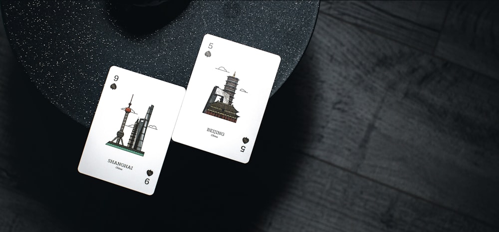 9 and 5 playing cards on black surface