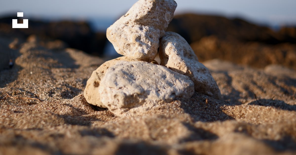 Four rocks on sand photo – Free Road Image on Unsplash