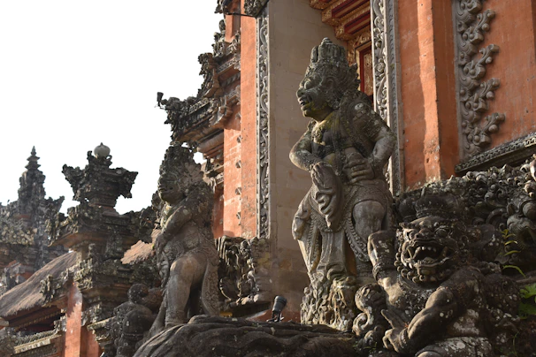 Artistic detail of Balinese carvings decorating the temple walls, showcasing rich cultural heritage.