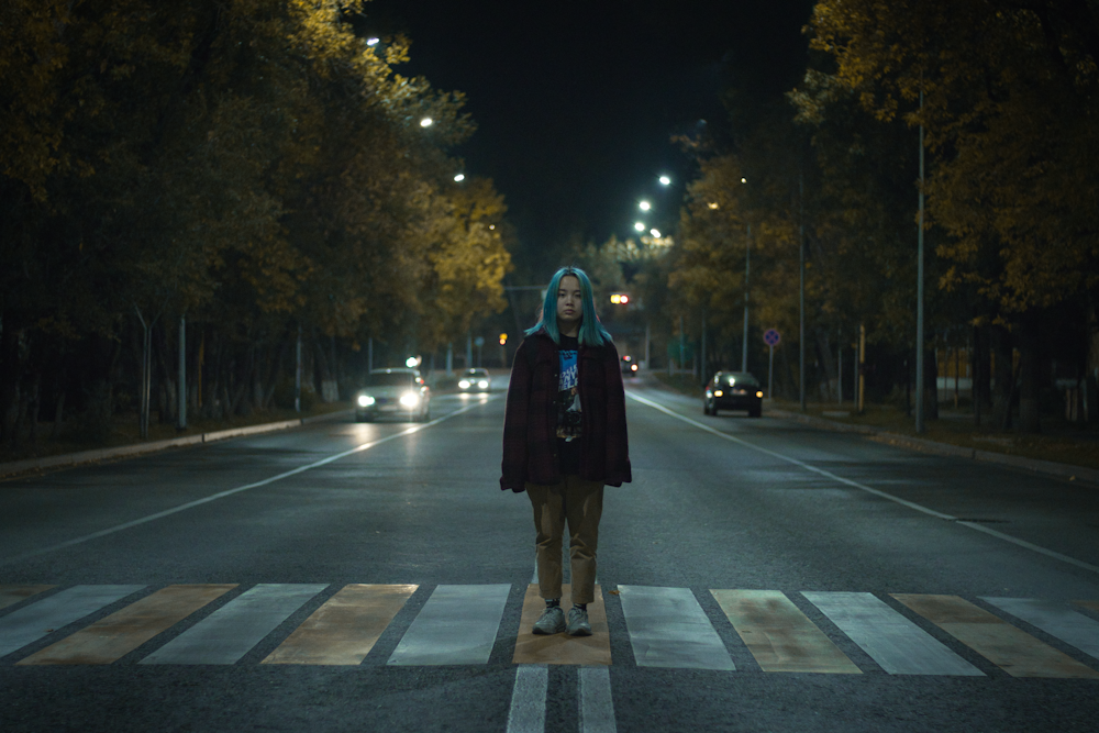 woman standing on pedestrian lane