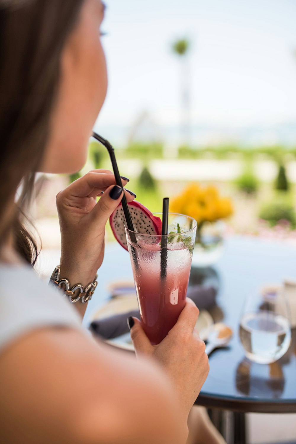 woman drinking dragon fruit juice