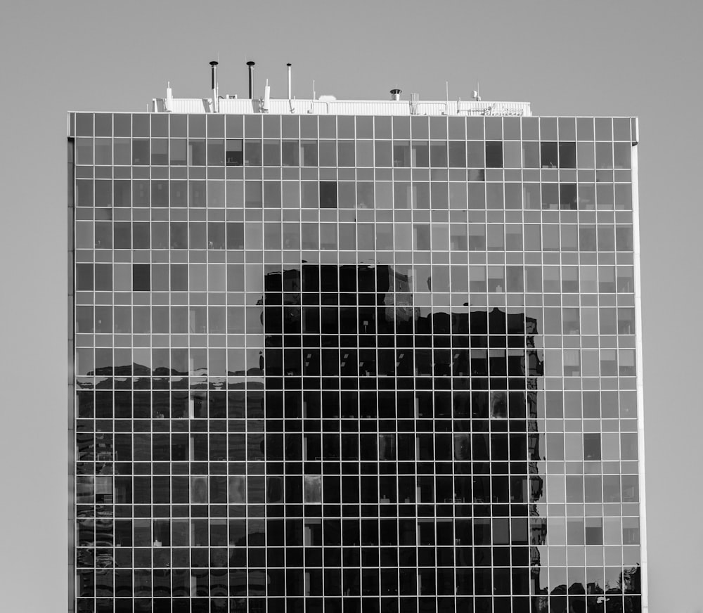 grayscale photography of glass walled building