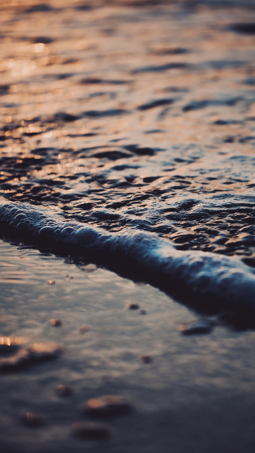 a close up of a wave on a beach