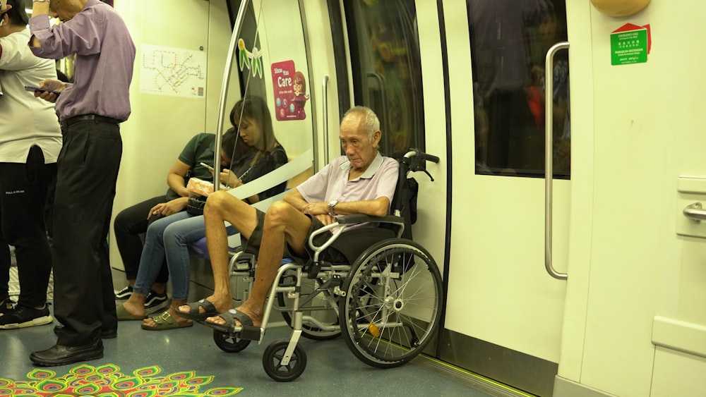 man sitting on black wheelchair
