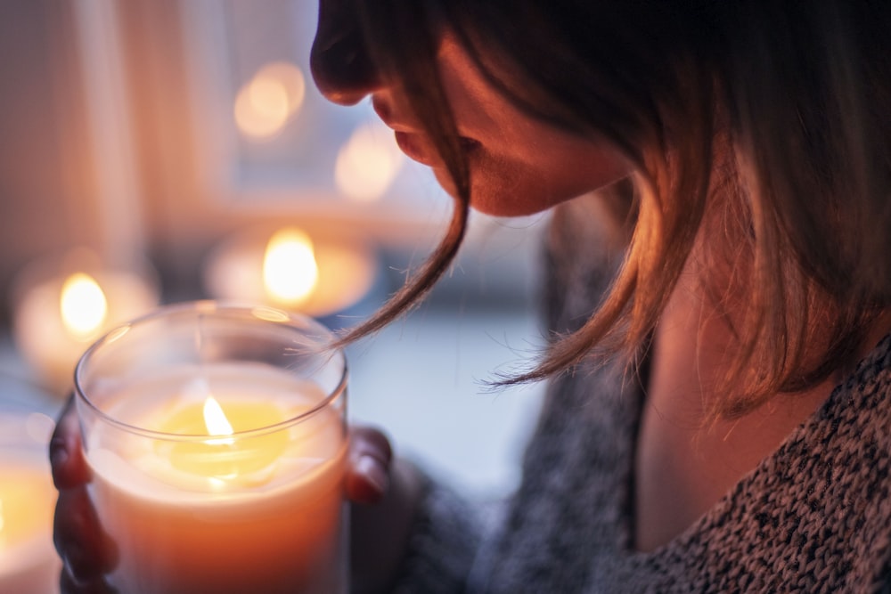 woman holding glass with candle