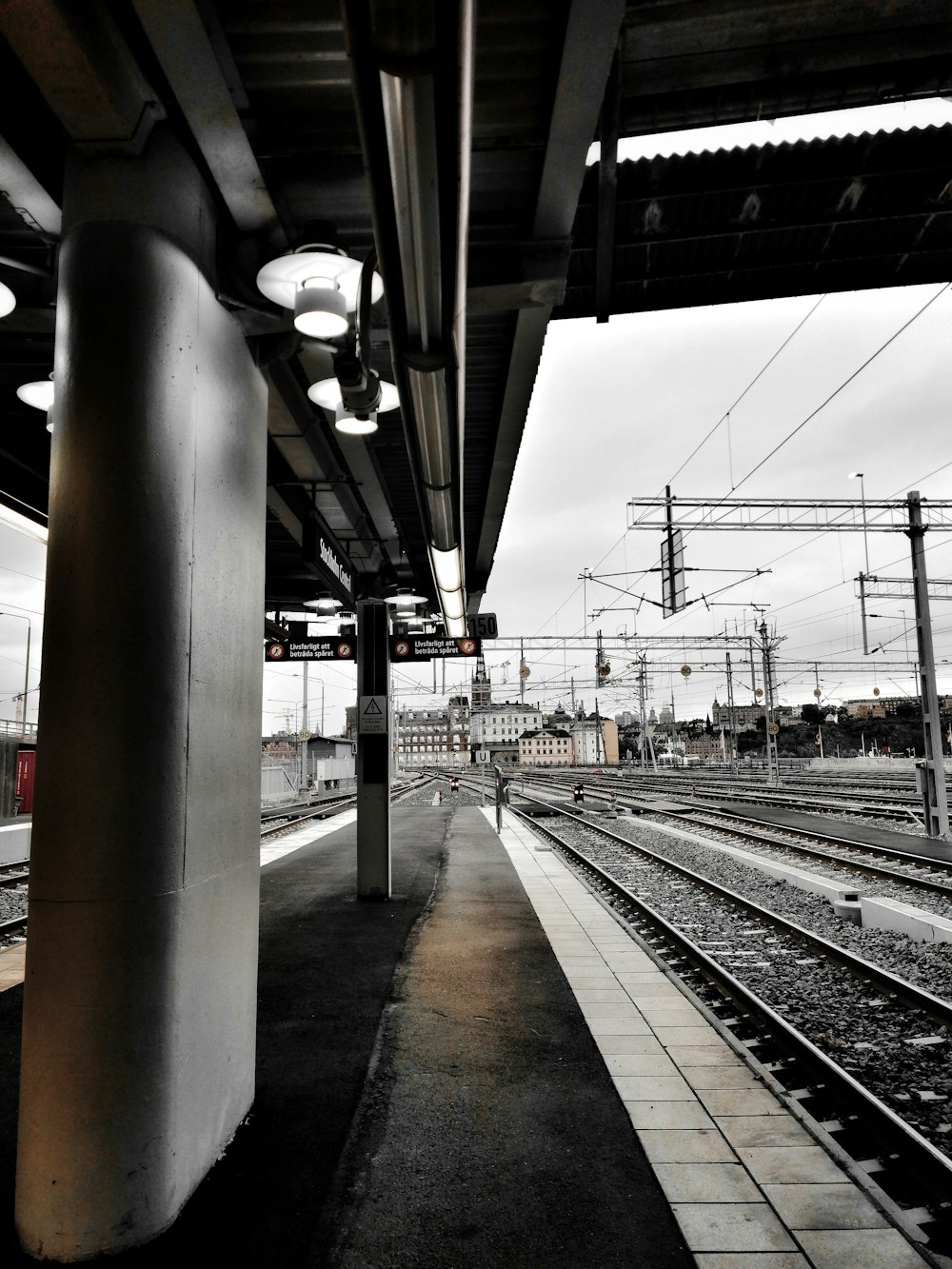 gray train rail near pillar
