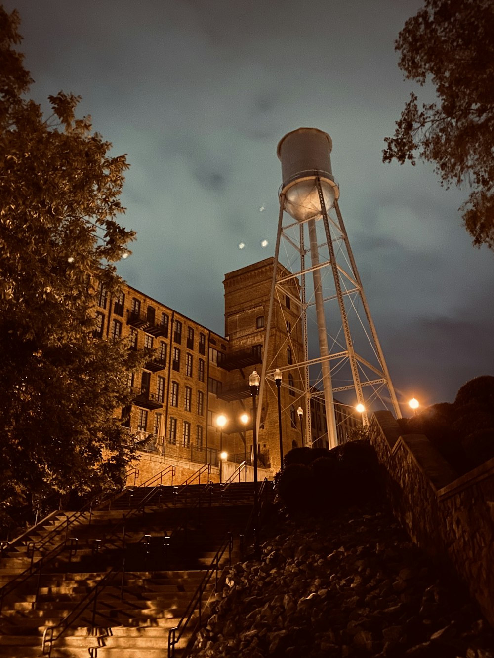 brown concrete building near water tank during night time