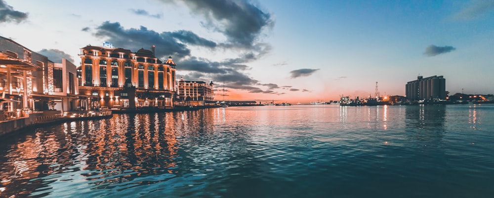 landscape photo of buildings by a lake