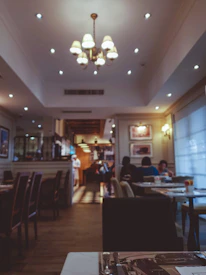 Cozy restaurant interior with dark tones and warm accent lighting showcasing a premium dining atmosphere.