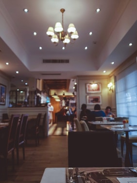 Cozy restaurant interior with warm lighting and a family enjoying a meal together.