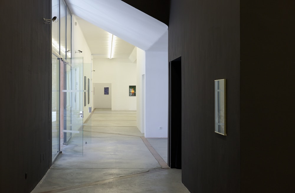 narrow hallway leading to an open glass door