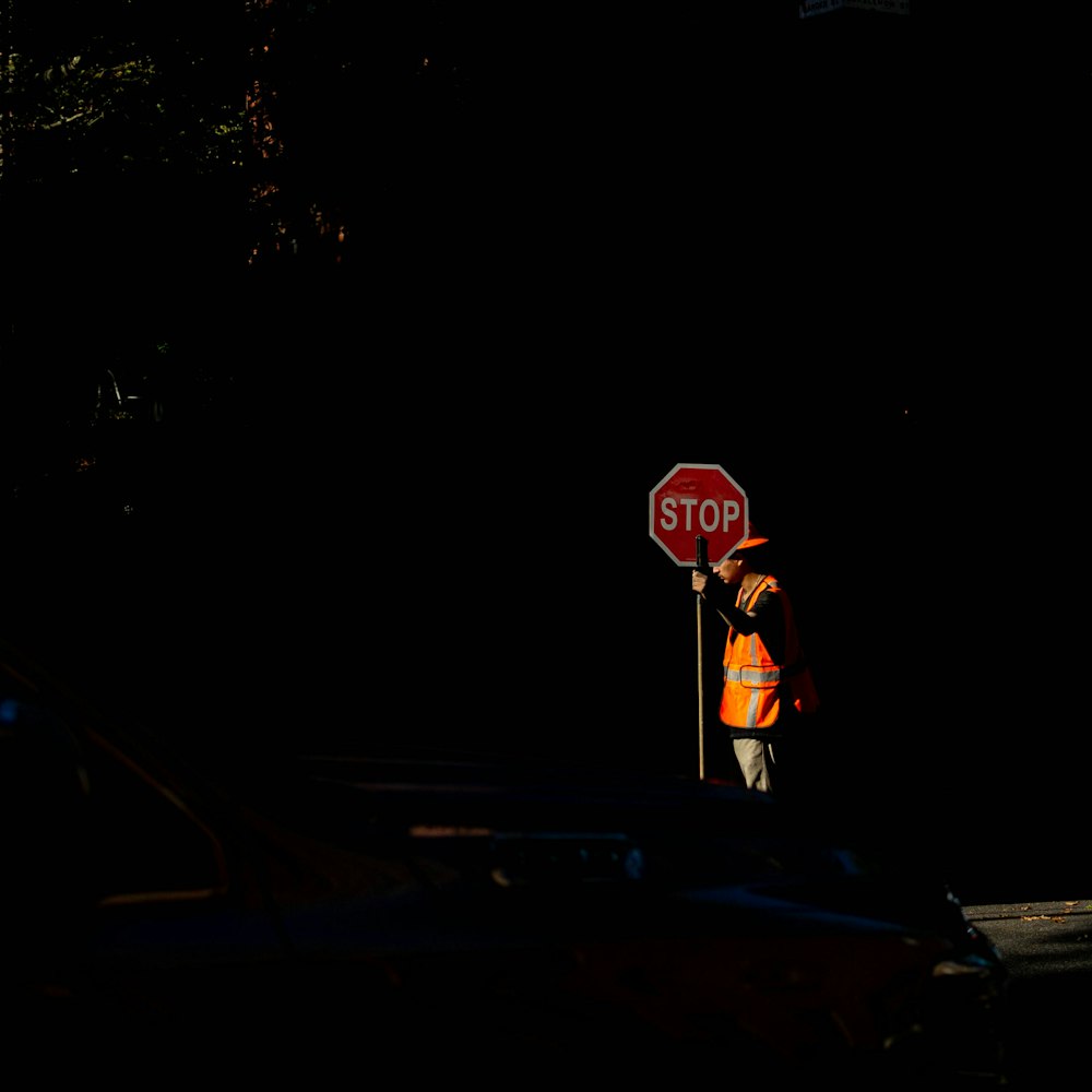 person standing near Stop signage