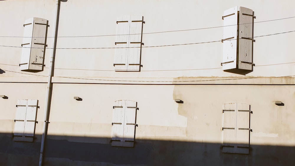 closed white wooden windows during daytime