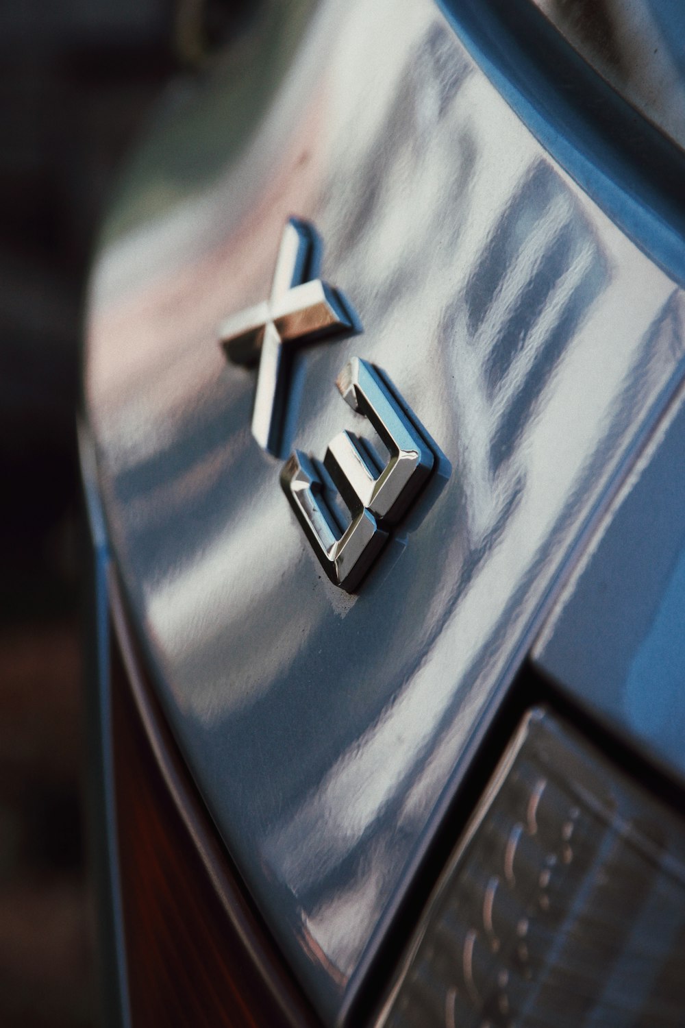 silver X3 car emblem