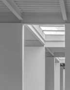 Architectural sketch overlaying a photo of a minimalist kitchen with clean lines and natural materials.