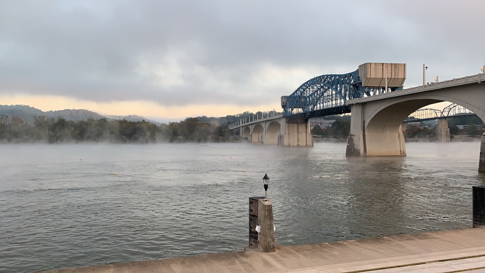 river under a white and blue bridge