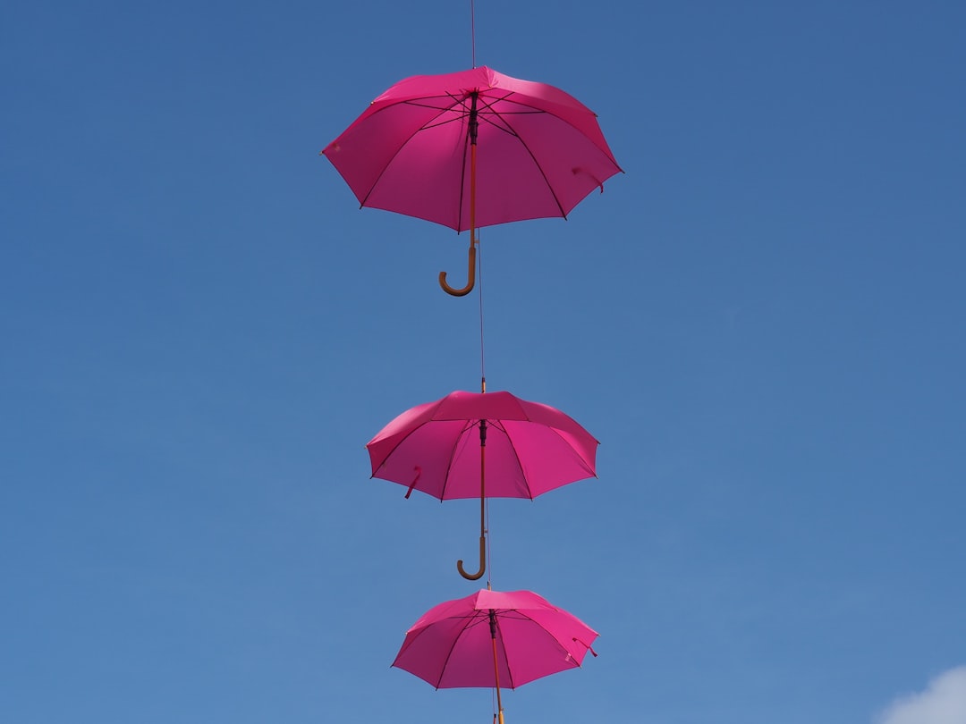 three hanging pink umbrellas