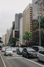 vehicles on road way surrounded by buildings
