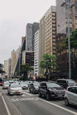 vehicles on road way surrounded by buildings