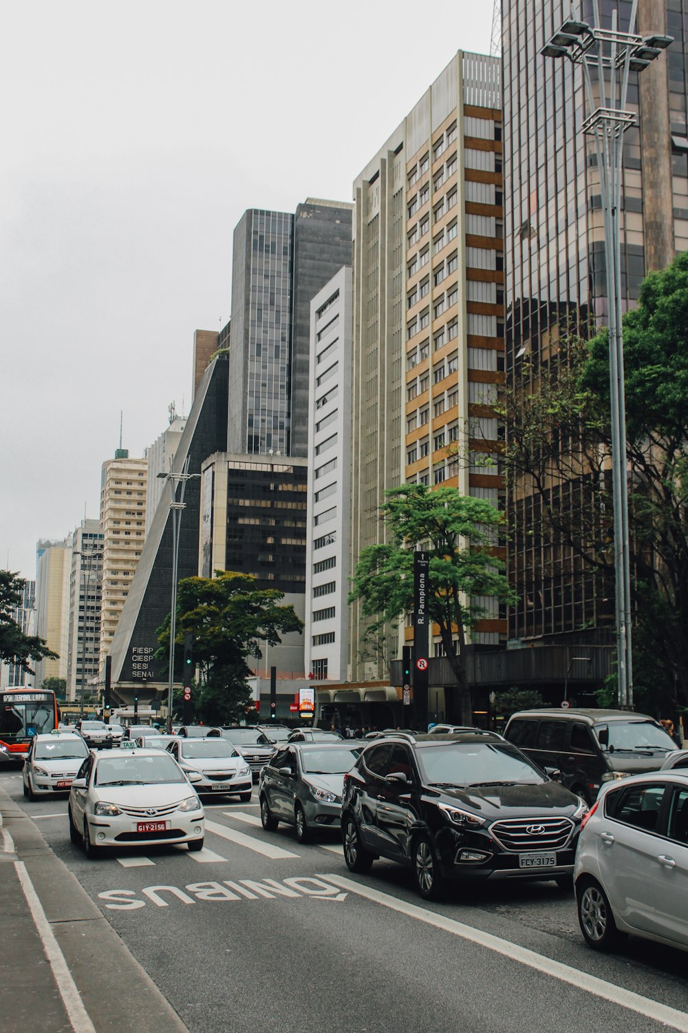 vehicles on road way surrounded by buildings