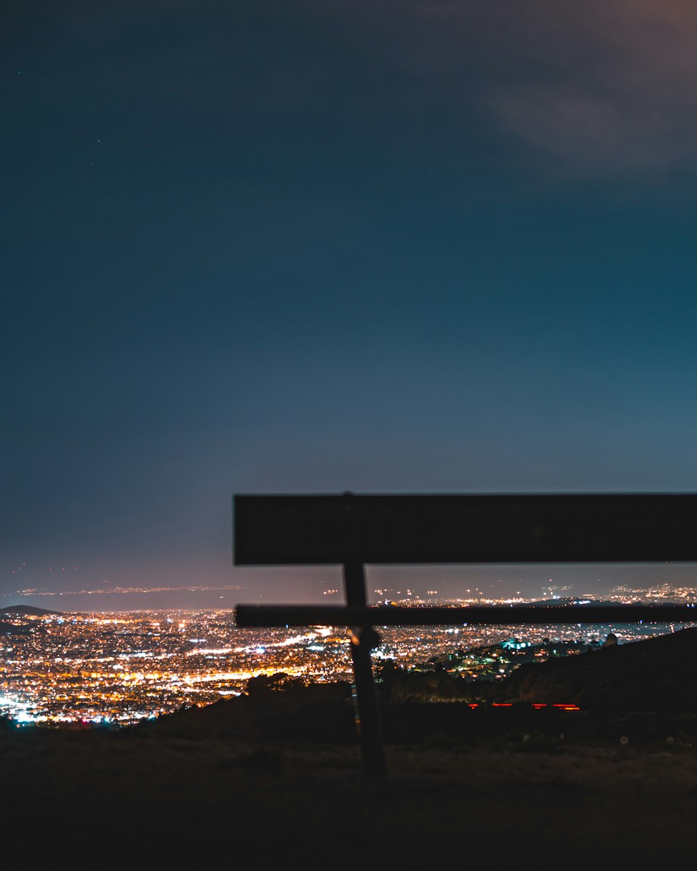 empty bench on high ground with cityscape view photo