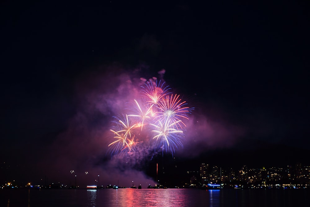 fireworks across body of water at night