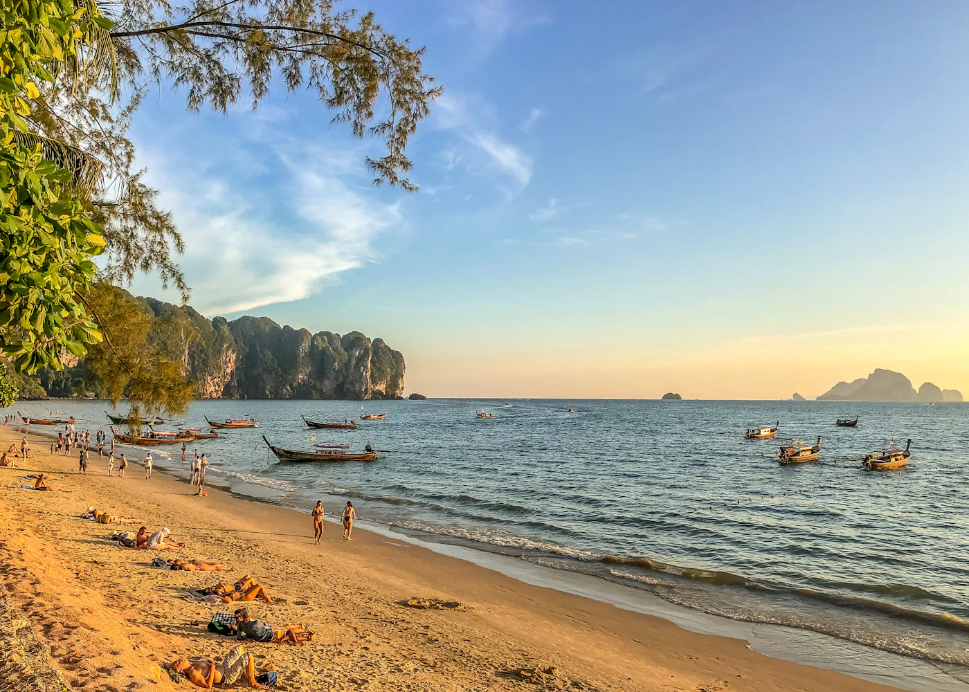 People walking beside a tropical shoreline