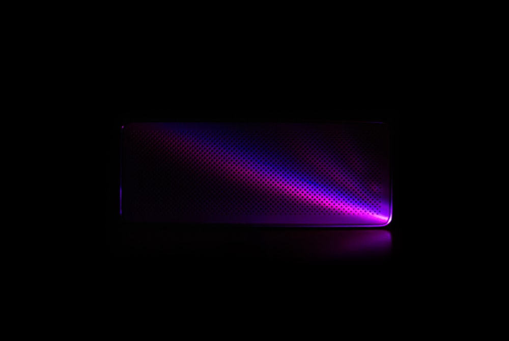 a black background with a purple and red light
