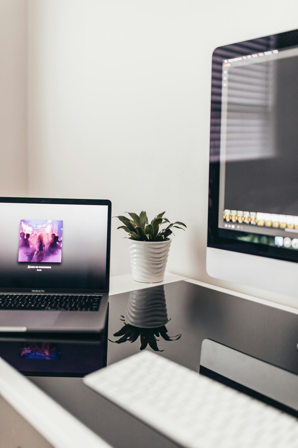 MacBook Pro beside iMac