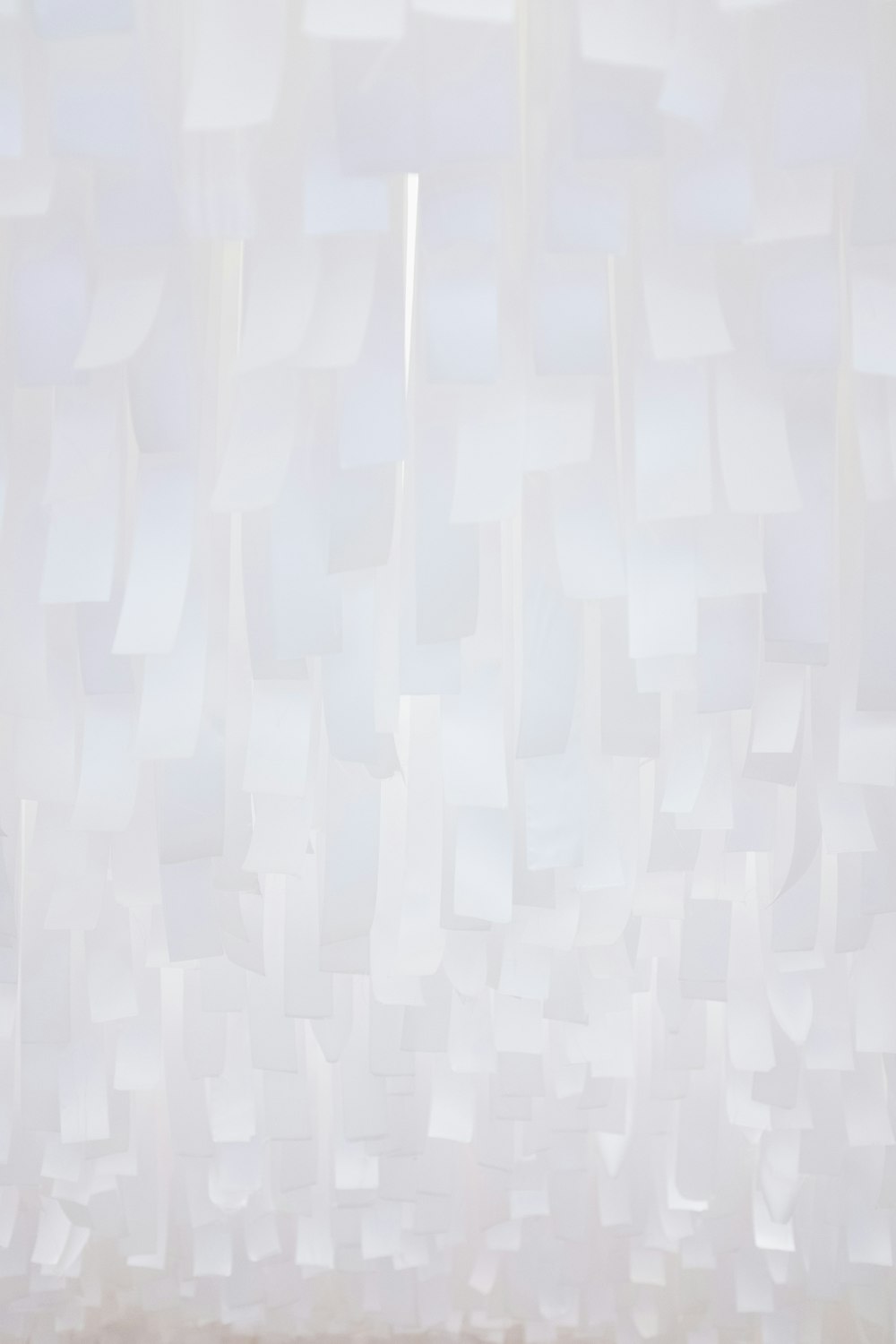 a white wall with a bunch of white squares on it